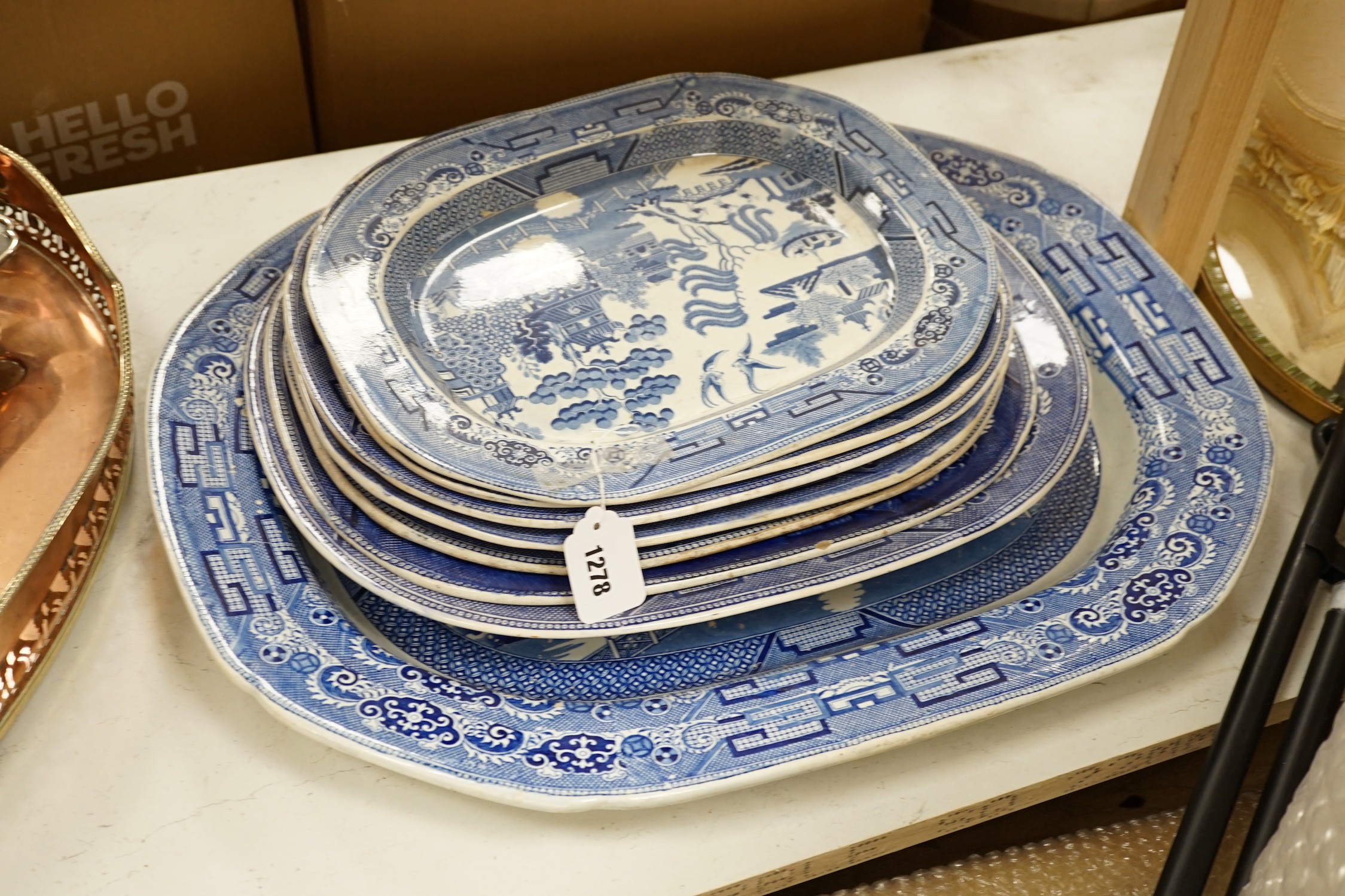 A 19th century transfer-printed large blue and white platter and seven similar smaller platters (8), largest 62cms wide